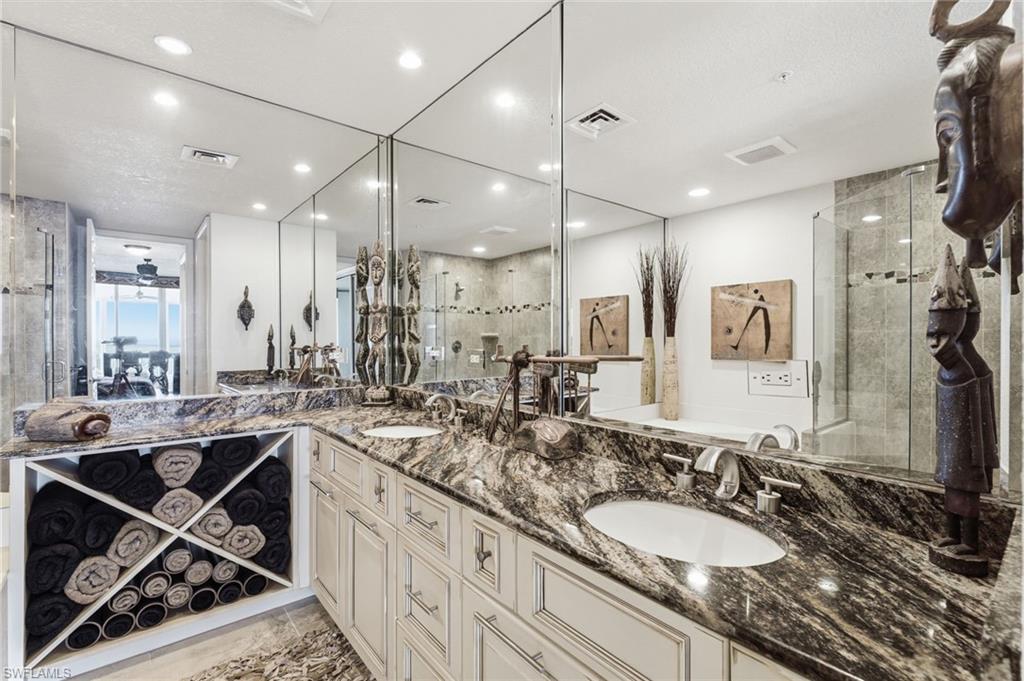 The redesigned primary ensuite bath has been thoughtfully reimagined as a luxurious private retreat, featuring custom cabinetry with exceptional storage, a relaxing soaking tub, and a separate walk-in shower. Every detail has been carefully curated to create a spa-inspired atmosphere of comfort, elegance, and sophistication.