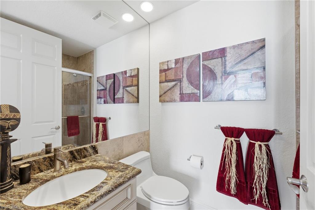 The third bedroom’s private ensuite bathroom offers a refined and comfortable retreat, featuring an elegant granite countertop and a beautifully appointed walk-in shower, creating a sophisticated space for guests to enjoy.
