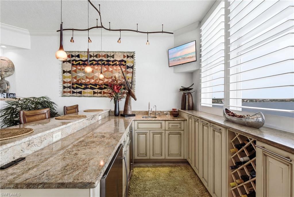 Your custom waterfront bar is designed for effortless entertaining, featuring a built-in wine rack, elegant granite countertops, a dedicated refrigerator, and an icemaker—creating the perfect gathering space to enjoy cocktails, fine wine, and breathtaking waterfront views.