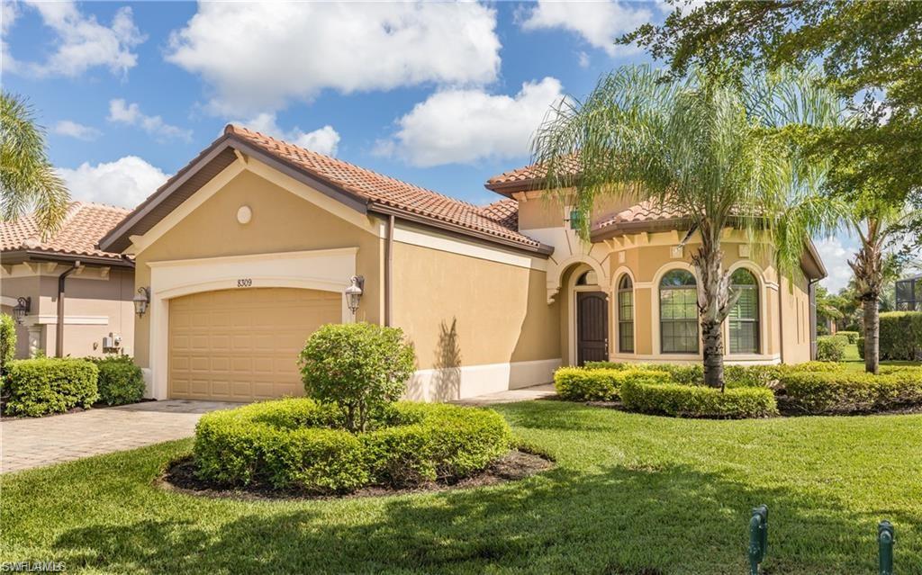 Mediterranean / spanish-style home with stucco siding, a garage, a front yard, and driveway