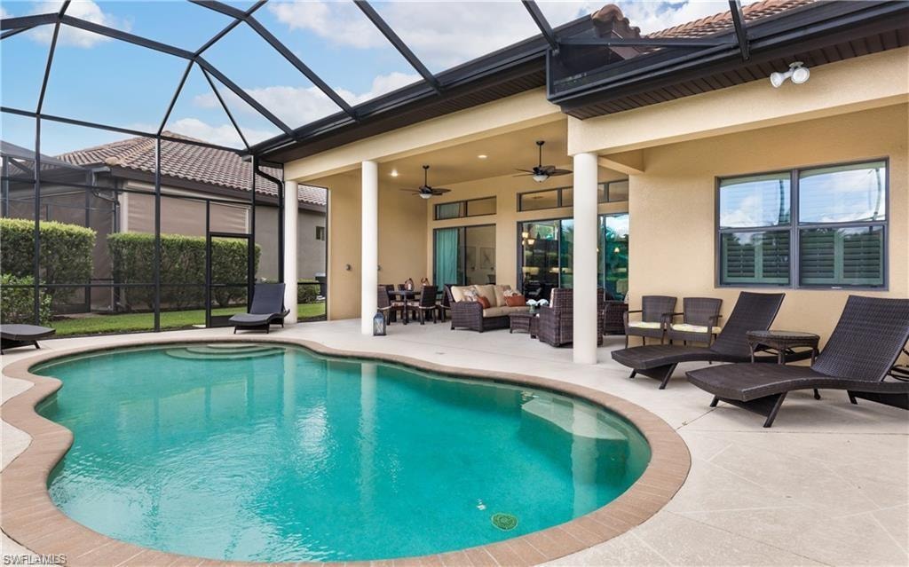 View of swimming pool featuring an outdoor hangout area, a lanai, a sunroom, and a patio area