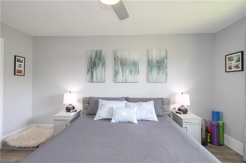 Bedroom featuring ceiling fan and hardwood / wood-style flooring