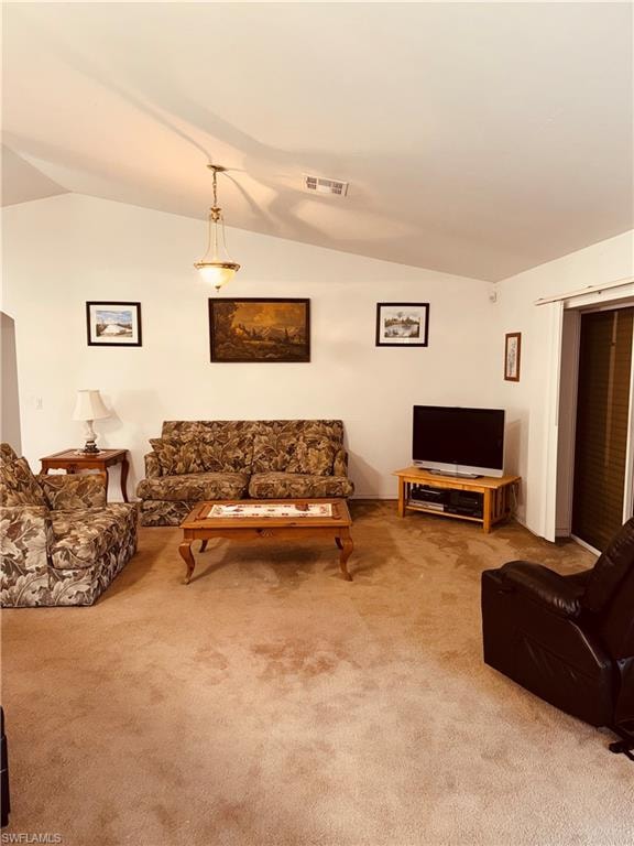 Living room with vaulted ceiling and carpet flooring