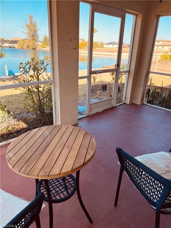 Sunroom / solarium featuring a water view
