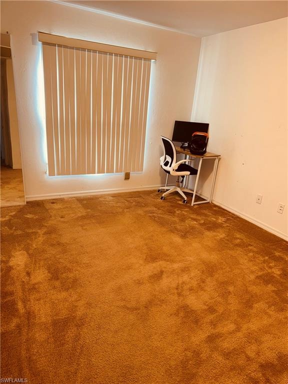 Unfurnished office with carpet flooring and baseboards