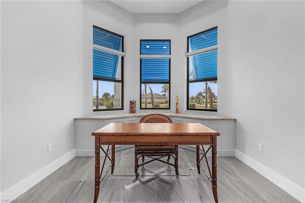 Home office with light hardwood / wood-style flooring and plenty of natural light