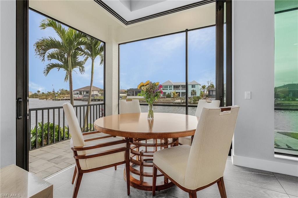 Tiled dining room with a water view