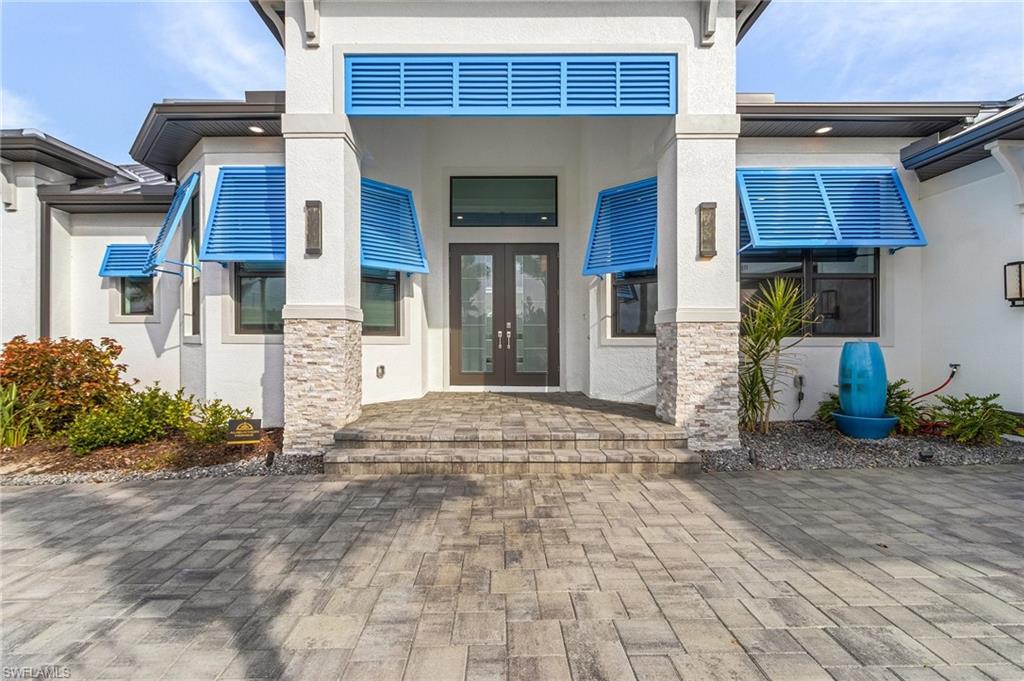 Property entrance featuring french doors