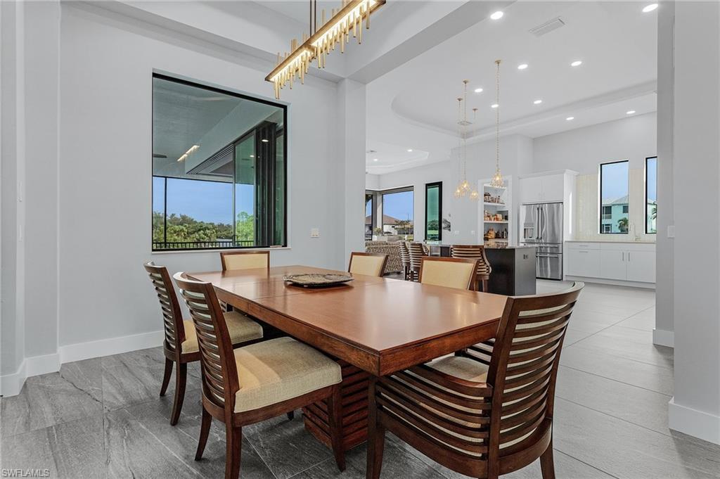 Tiled dining area with a chandelier