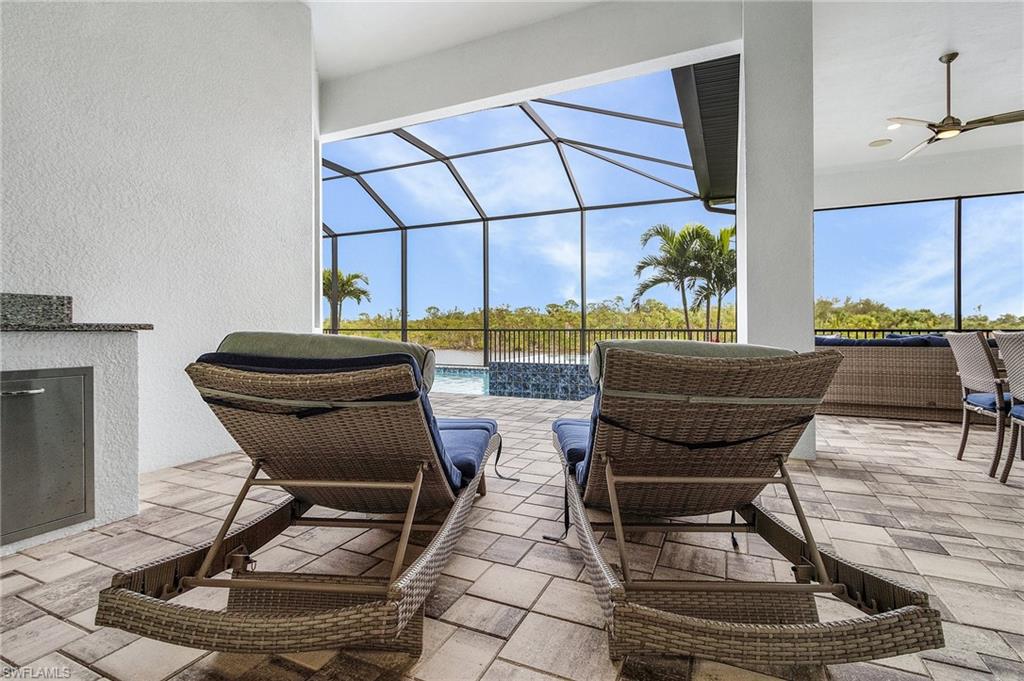 View of patio with ceiling fan and glass enclosure