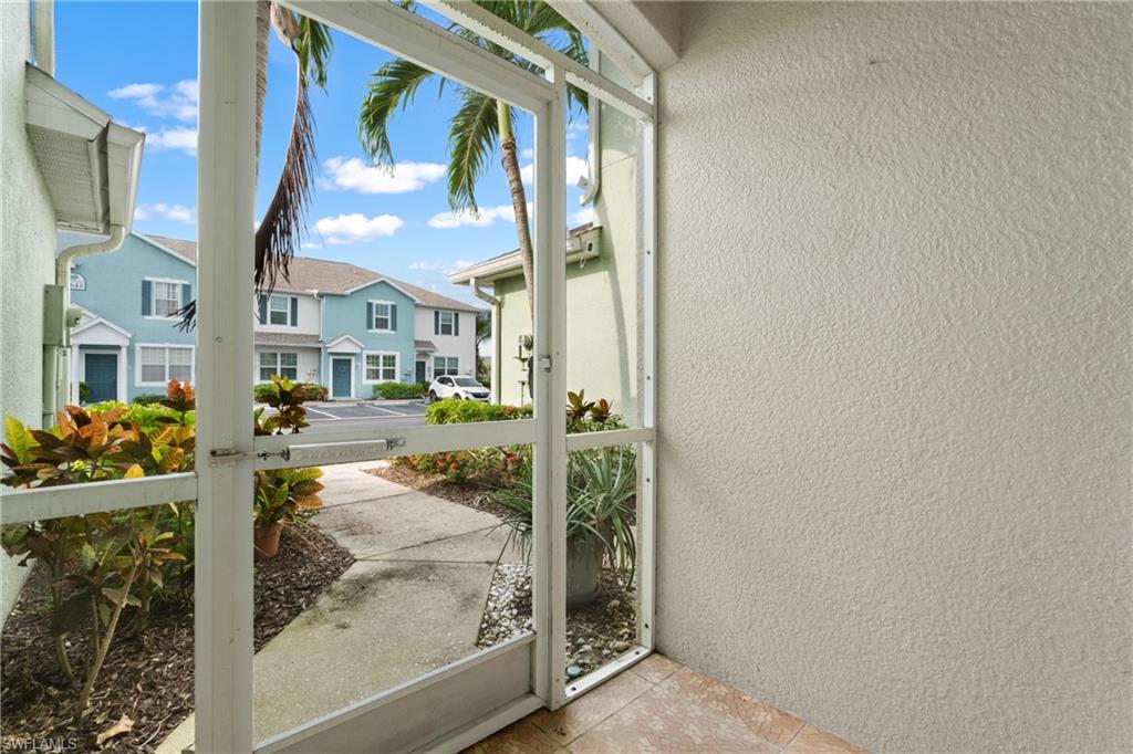 Screened patio with textured stucco wall and tile flooring