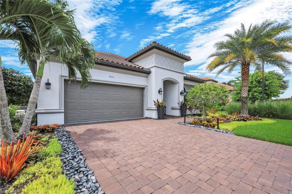 Mediterranean-inspired exterior with a tile roof and stucco siding