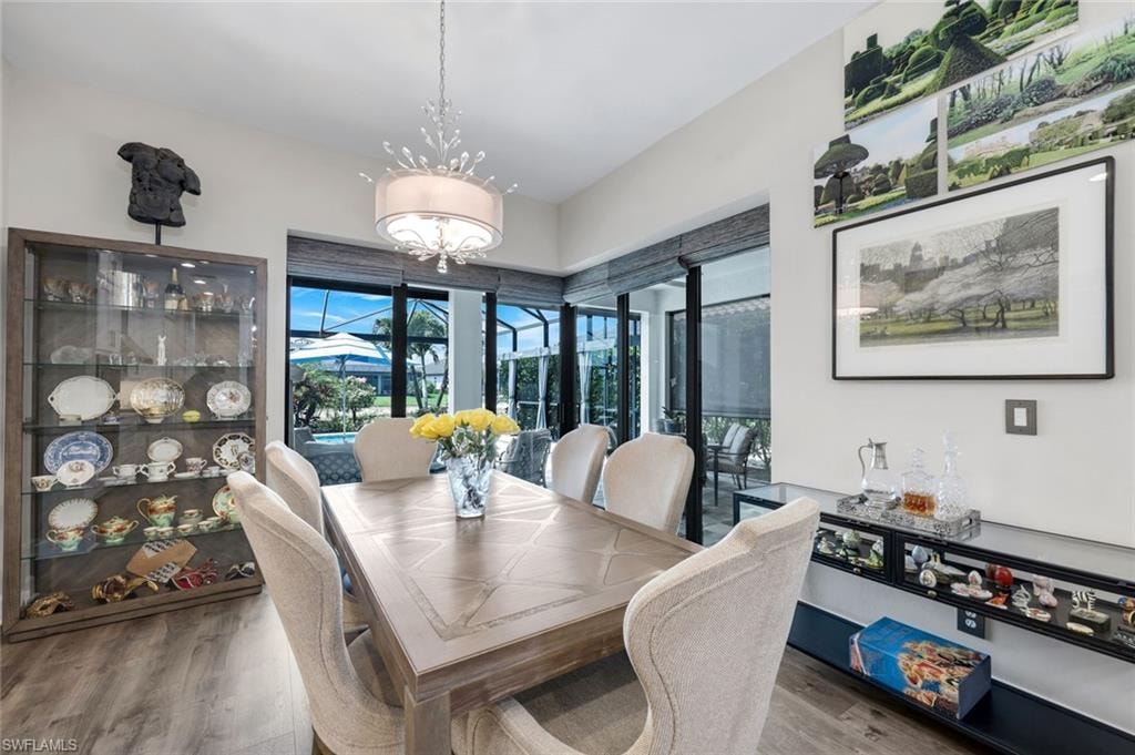 Dining area featuring wood-finish flooring and a decorative chandelier
