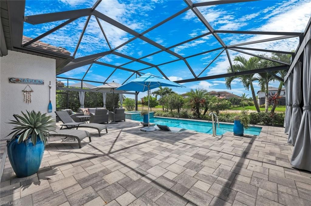 Screened lanai featuring a swimming pool and spa