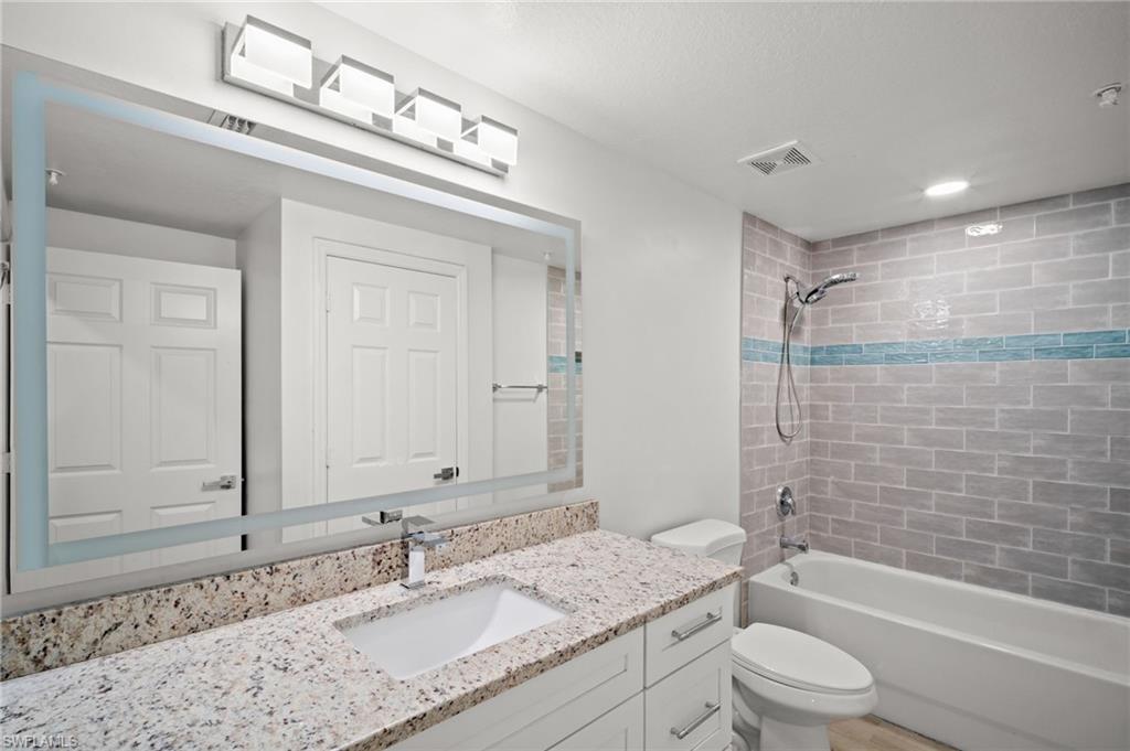 Full bathroom featuring vanity and shower / washtub combination