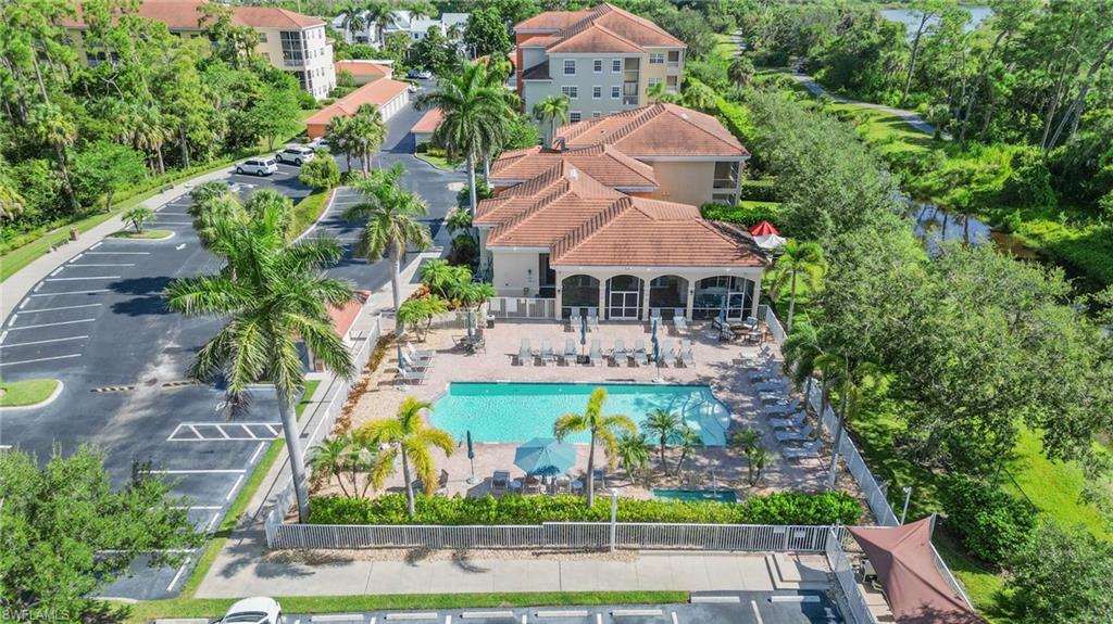 Aerial view of a pool area and a tree filled landscape