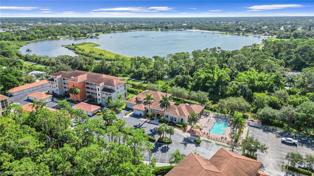 Bird's eye view of a nearby body of water and a pool