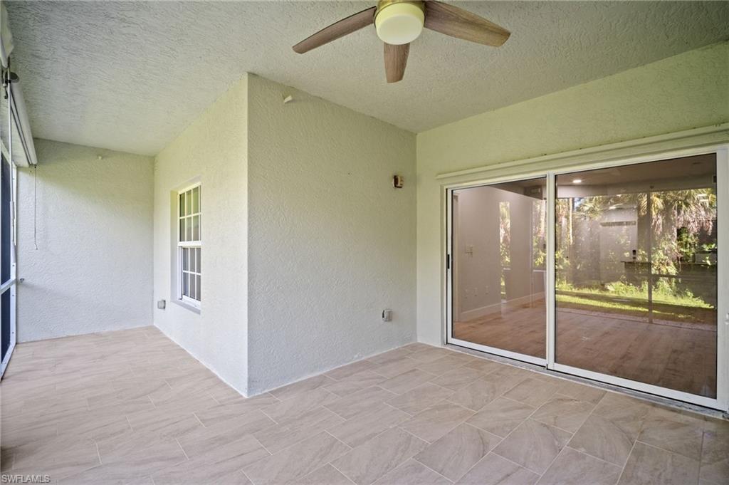 Unfurnished sunroom with a ceiling fan