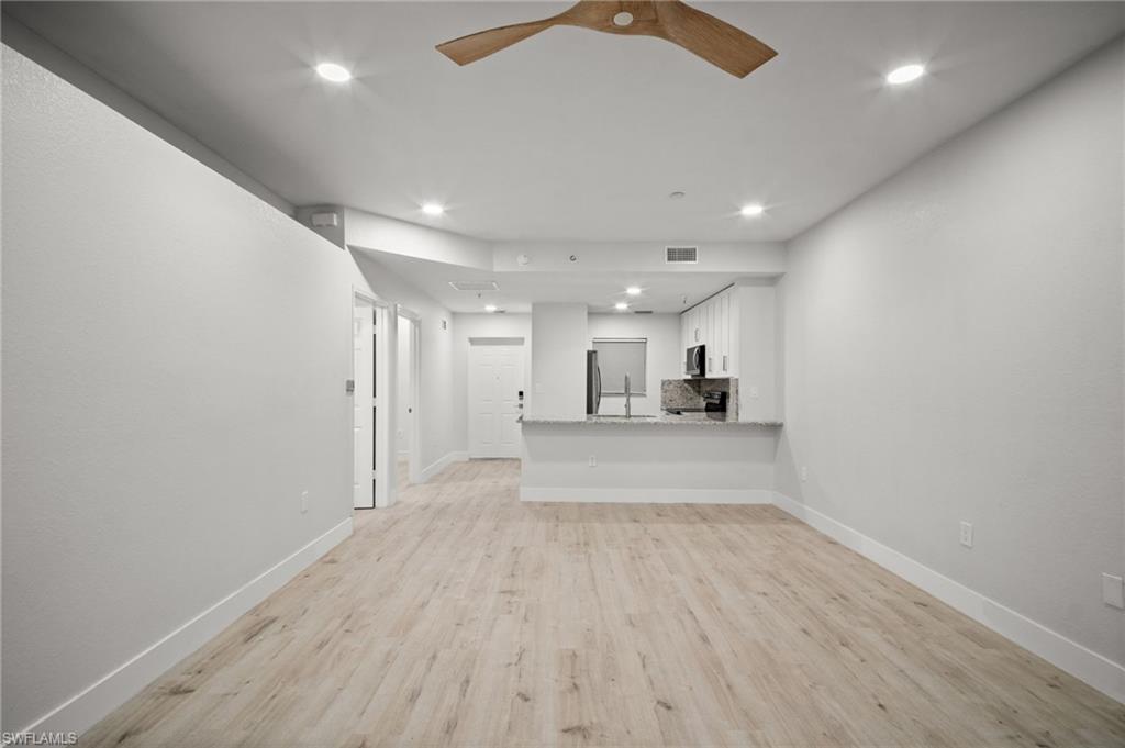 Unfurnished living room with light wood-type flooring, recessed lighting, and a ceiling fan