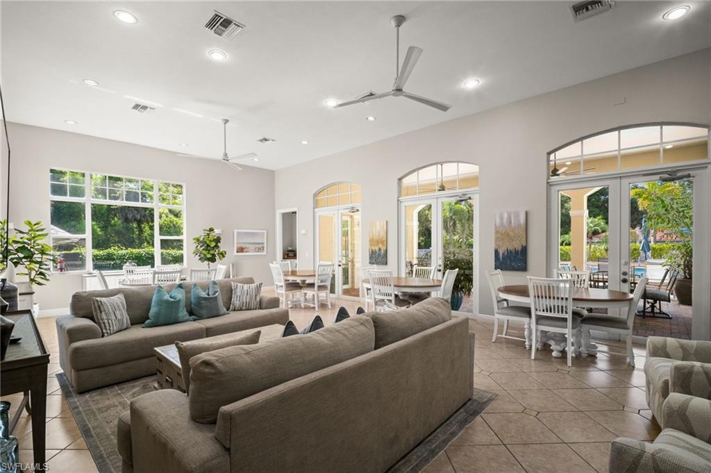Living area with ceiling fan, french doors, light tile patterned floors, recessed lighting, and healthy amount of natural light