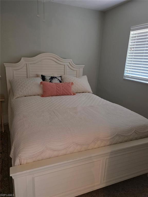 Carpeted room with a ceiling fan