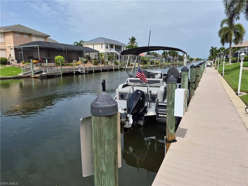 Waterfront property featuring a private boat dock, composite decking, and canal access