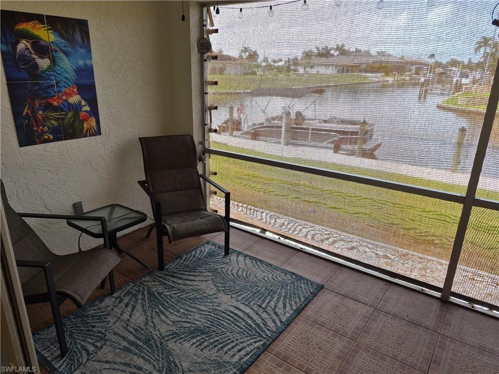 Screened patio with tiled flooring and a serene  waterfront outlook