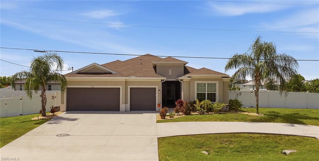 Contemporary stucco exterior with a hip roof and twin garage doors