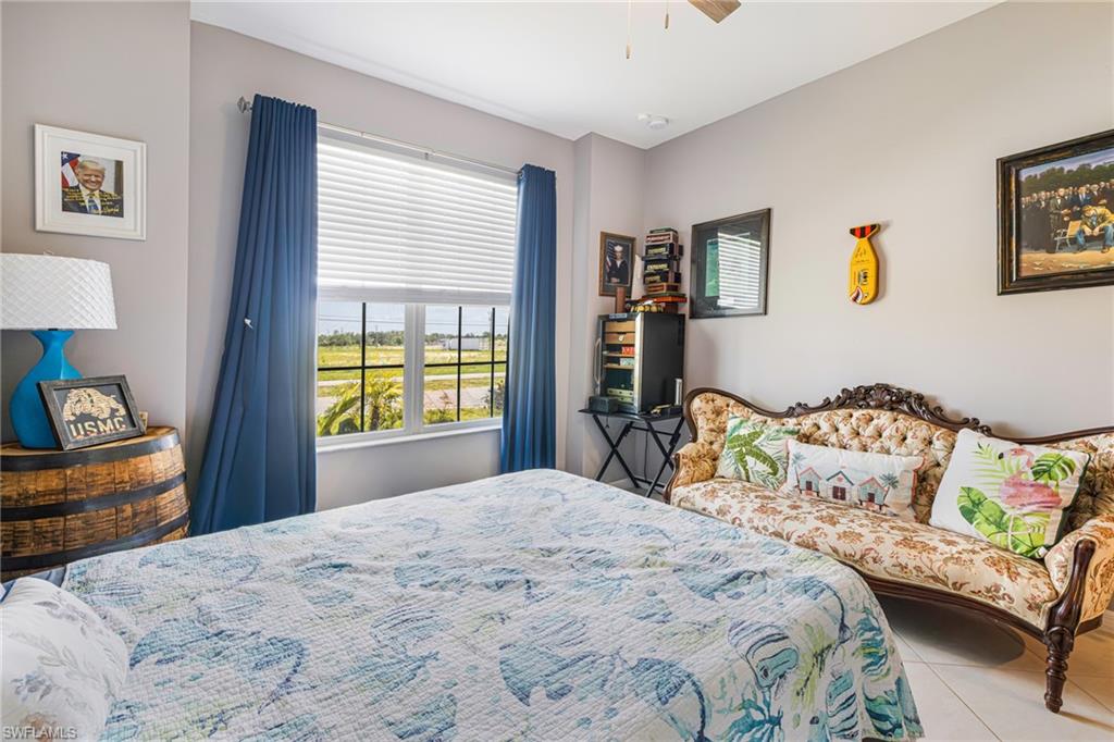 Spacious room featuring a large window with horizontal blinds, providing natural light and exterior visibility