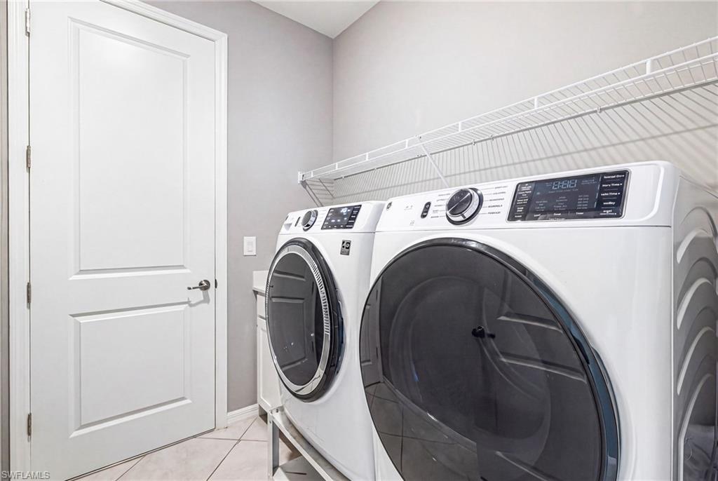 Dedicated laundry area featuring a white two-panel door, wire shelving, light gray wall paint, and diagonal tile flooring