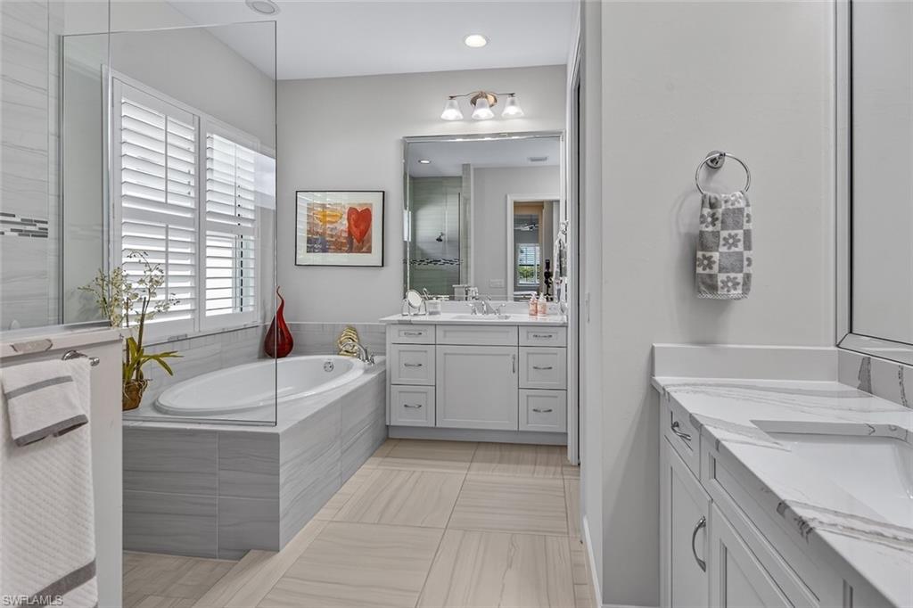 Your private spa retreat featuring a soaking tub, dual vanities, and walk-in shower.