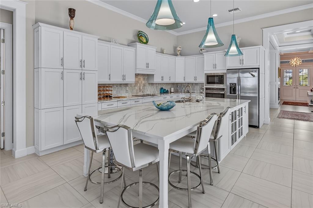 An entertainer's kitchen with an expansive island and abundant storage.