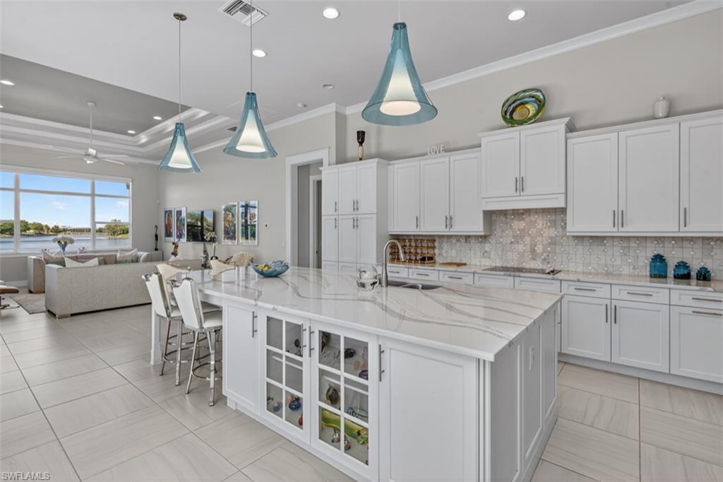 Abundant cabinetry, expansive workspace, and seamless flow to the great room.