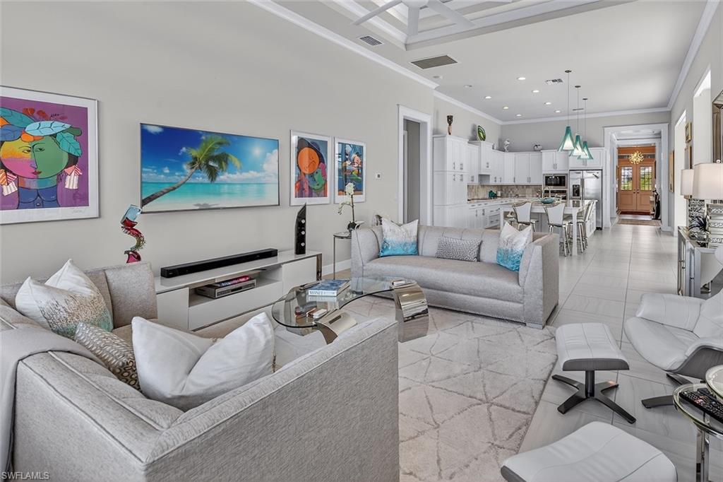 Designed for gathering, this open great room connects beautifully to the gourmet kitchen and lanai.