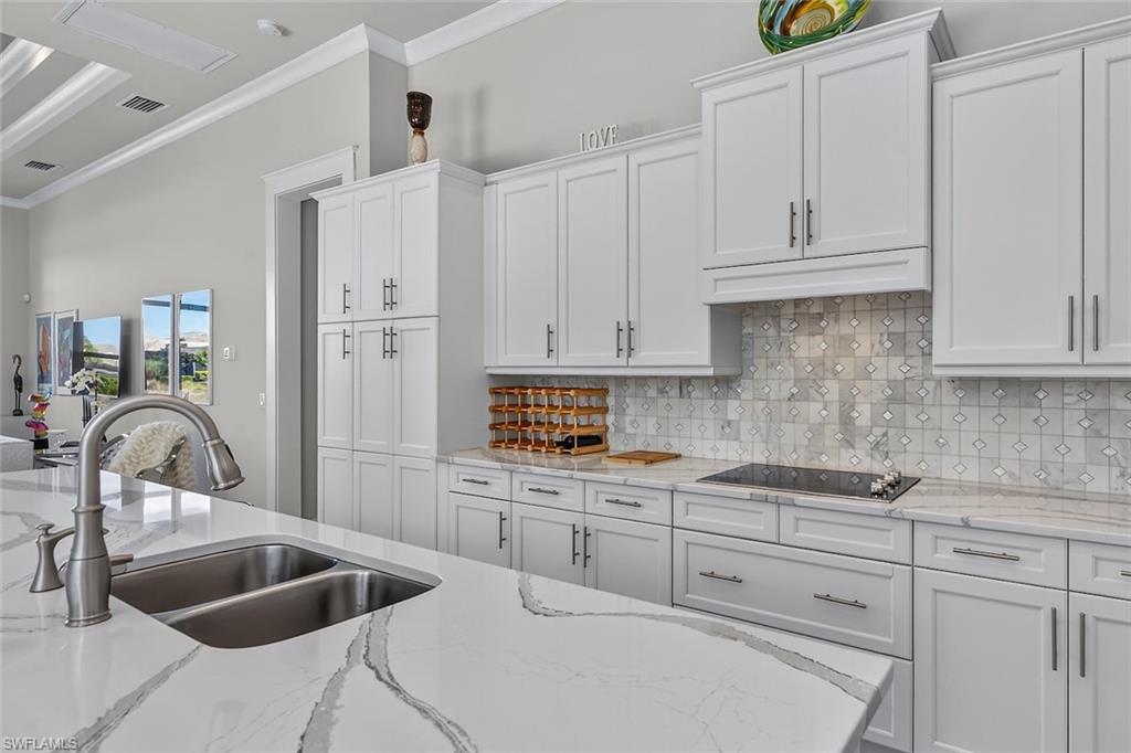 Quartz countertops, custom cabinetry, and generous prep space for everyday living.