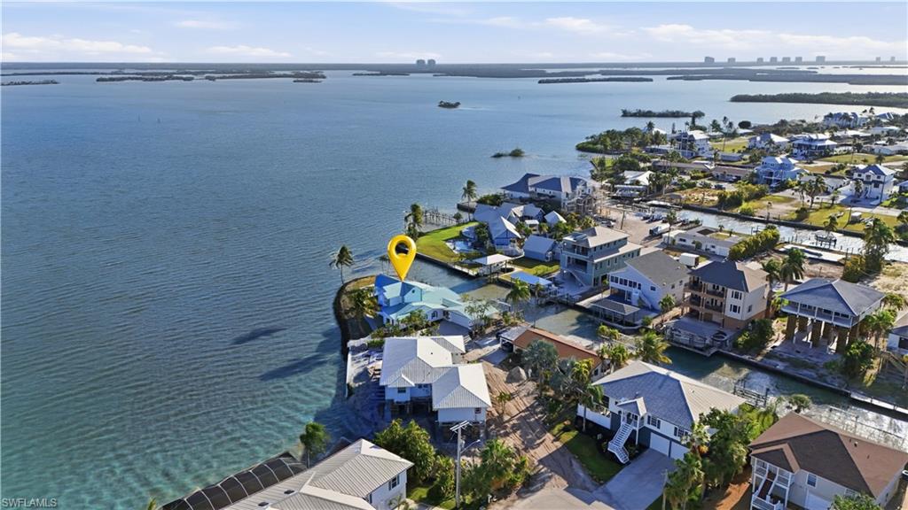 Aerial perspective of suburban area featuring a nearby body of water - Virtually Edited Image