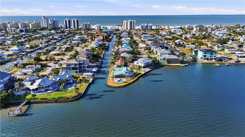 Aerial perspective of suburban area featuring a nearby body of water - Virtually Edited Image
