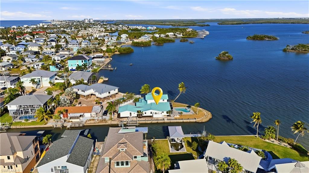 Aerial view of property and surrounding area featuring nearby suburban area - Virtually Edited Image