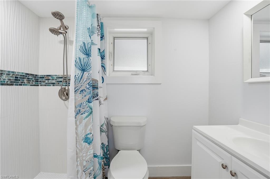 Full bathroom featuring a shower stall and vanity - Virtually Edited Image