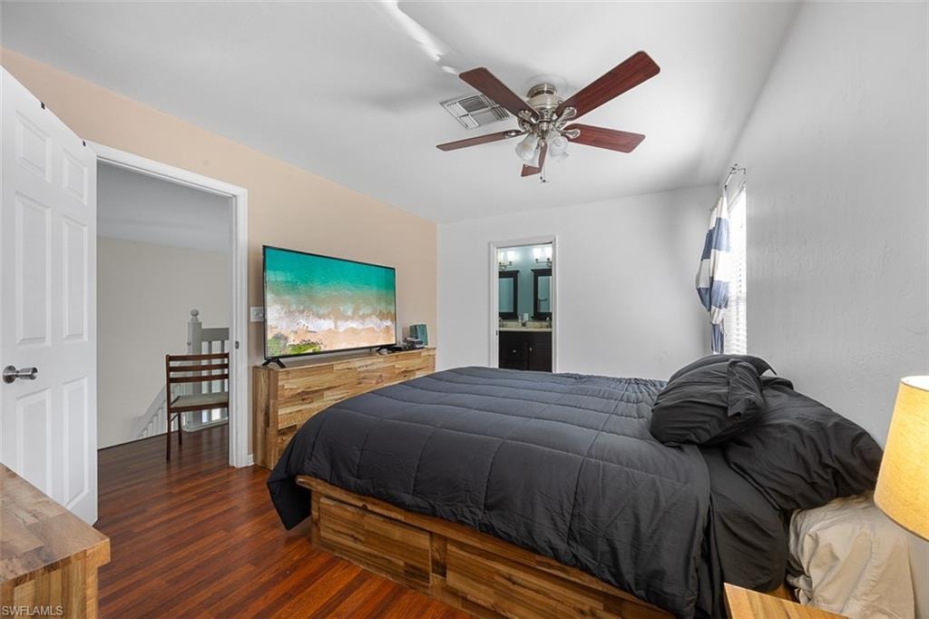 Bedroom featuring rich wood-finish flooring and a ceiling fan with integrated lighting