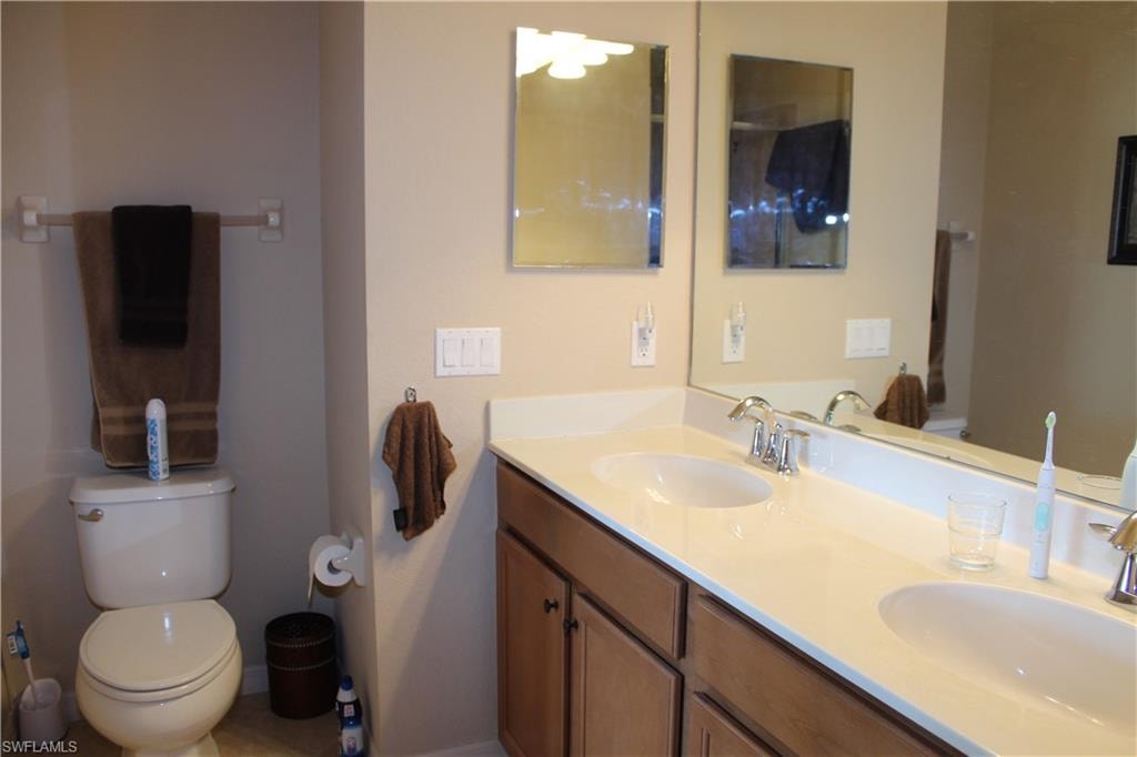 Master Bathroom featuring double vanity and light tile patterned flooring