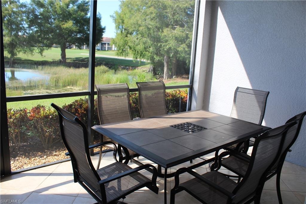 Back Sunroom / solarium featuring a water view
