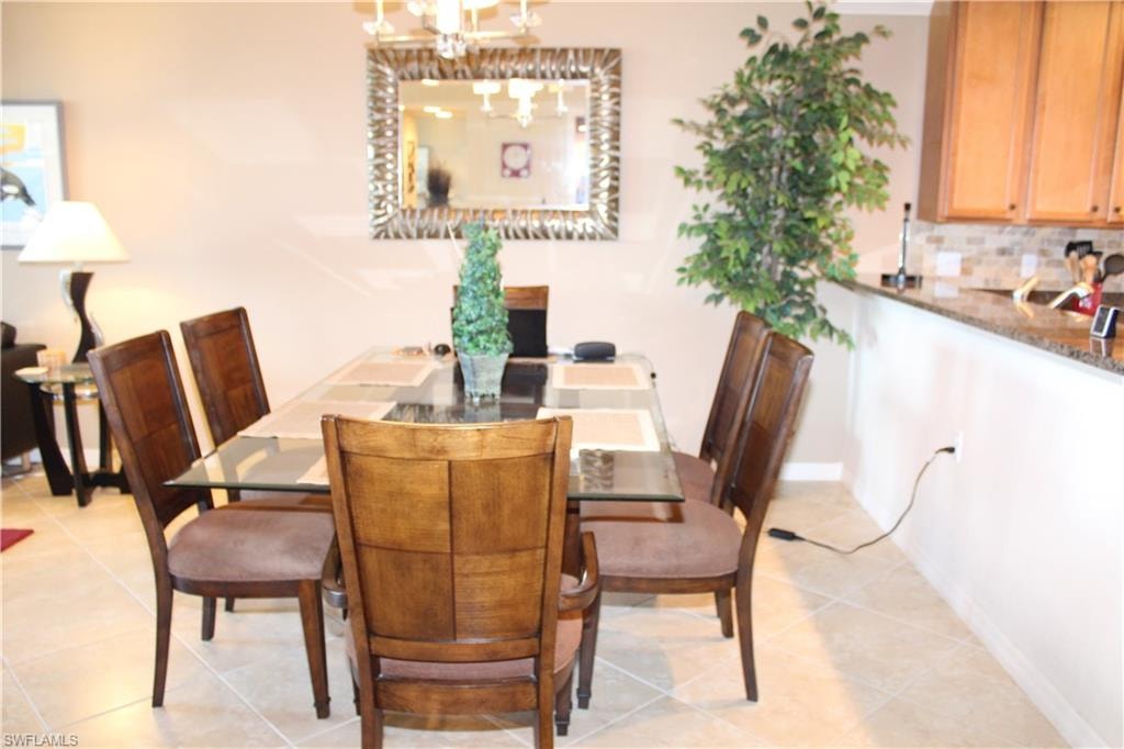 Dining area featuring light tile patterned flooring