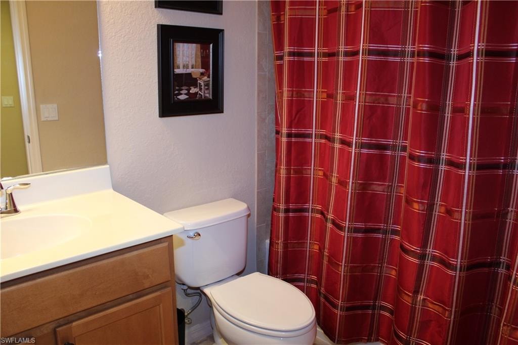 Guest Full bathroom featuring vanity, a shower with curtain, and a textured wall