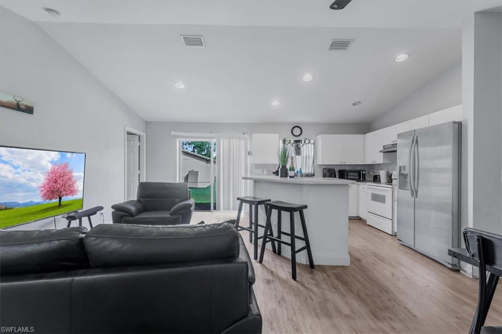 Open-concept living area with wood-finish flooring