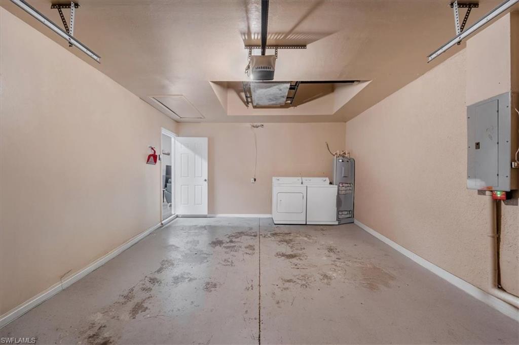 Spacious garage with concrete flooring and light-toned walls