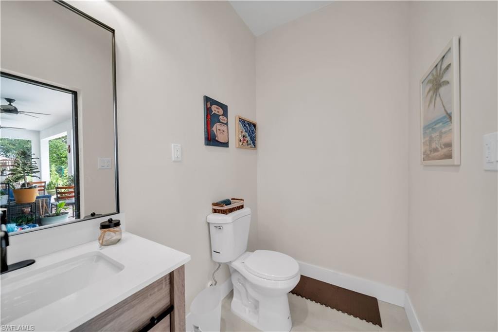 Bathroom featuring a contemporary vanity with a white countertop, an undermount sink, and a matte black faucet