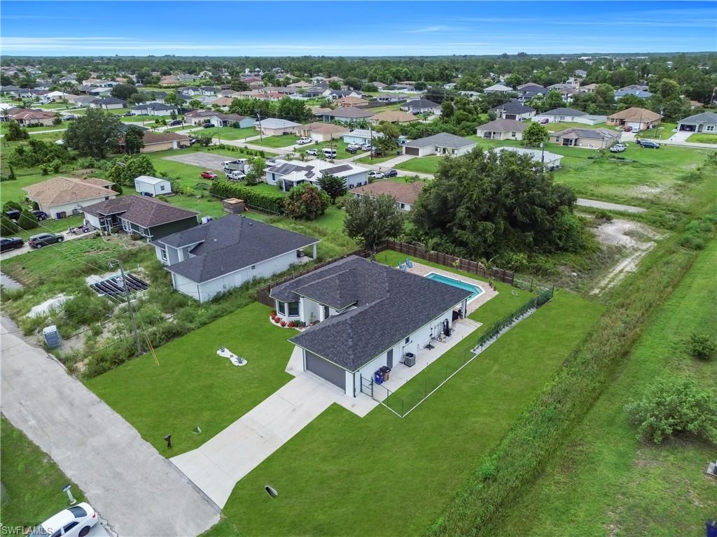 Contemporary single-story residence featuring a dark shingle roof and a light-colored exterior