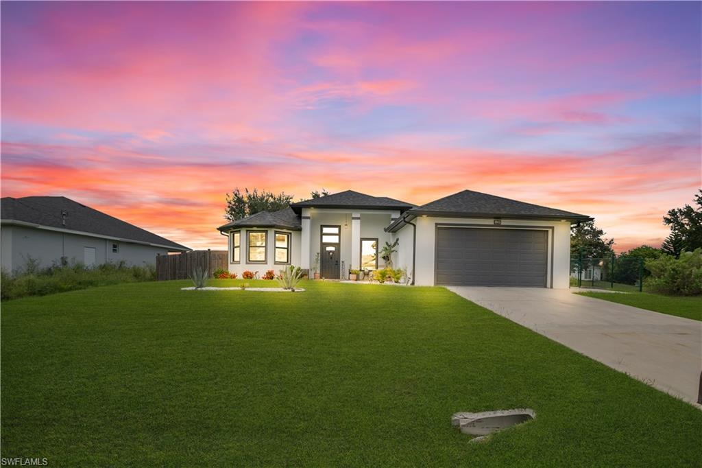 Contemporary single-story residence featuring a white stucco exterior with dark trim