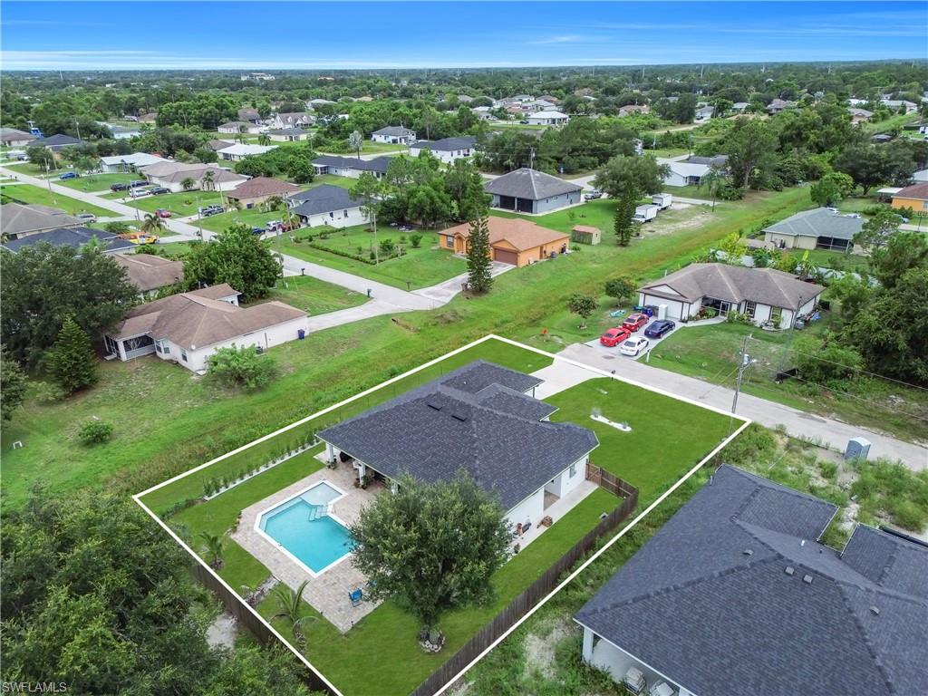 Aerial perspective showcasing a single-story residence with a dark shingle roof